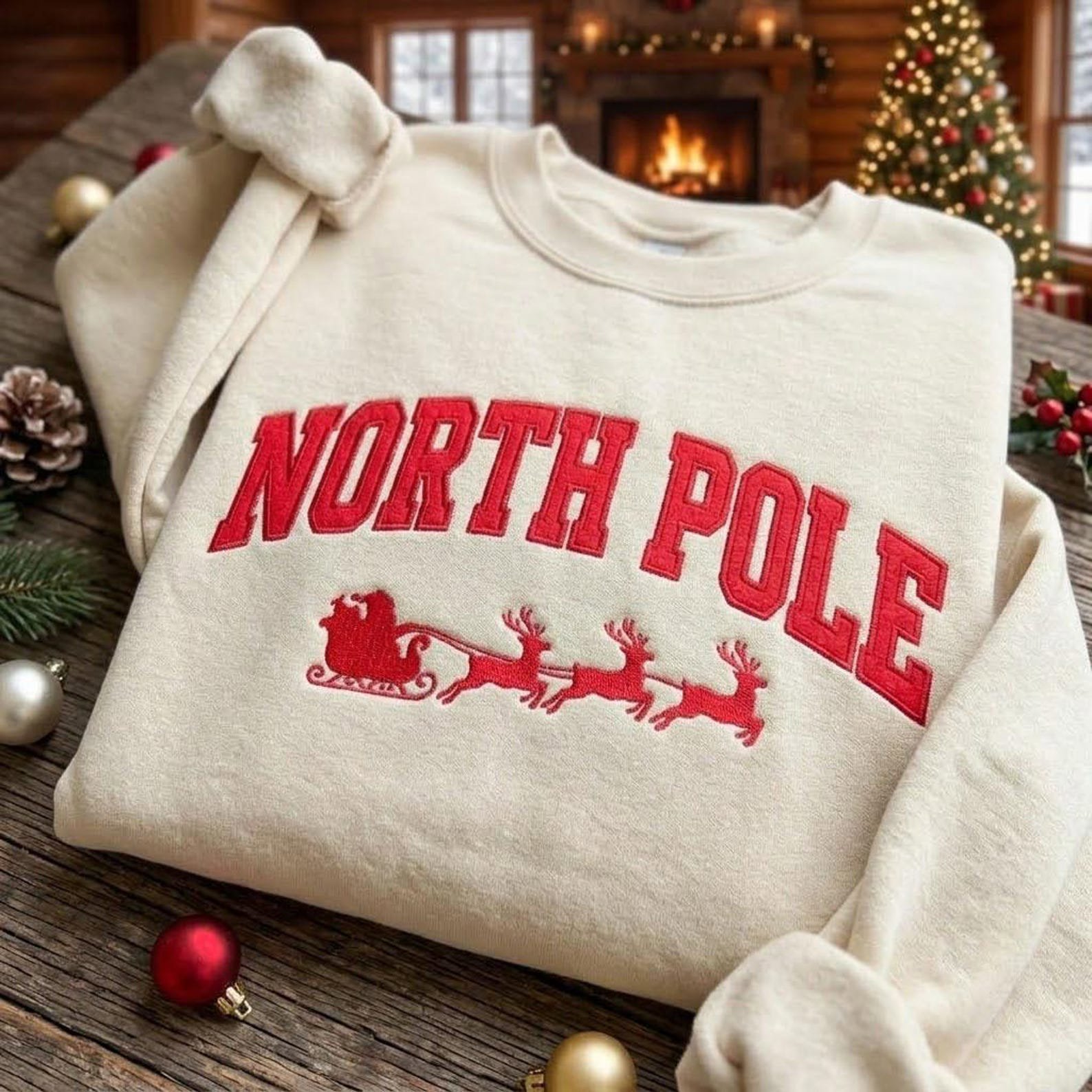 North Pole Christmas Embroidered Sweatshirt, Santa Sleigh Reindeer Crewneck, Collegiate Holiday Sweater, Festive Winter Pullover 1